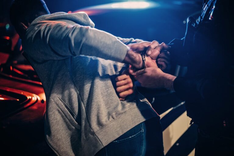 Miranda Rights | Person being arrested and placed in front of police car | Stefanie Murphy | Rhode Island Criminal Defense Attorney