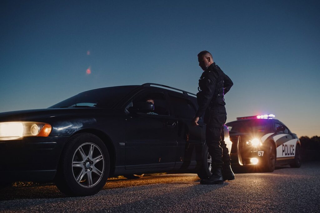 DUI arrest in Rhode Island | Police Officer outside of car he pulled over | Experienced DUI Attorney | Stefanie A. Murphy