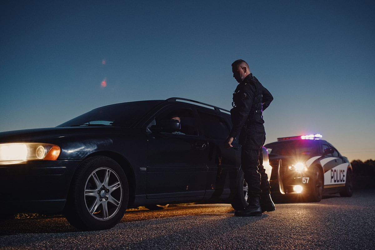 DUI arrest in Rhode Island | Police Officer outside of car he pulled over | Experienced DUI Attorney | Stefanie A. Murphy