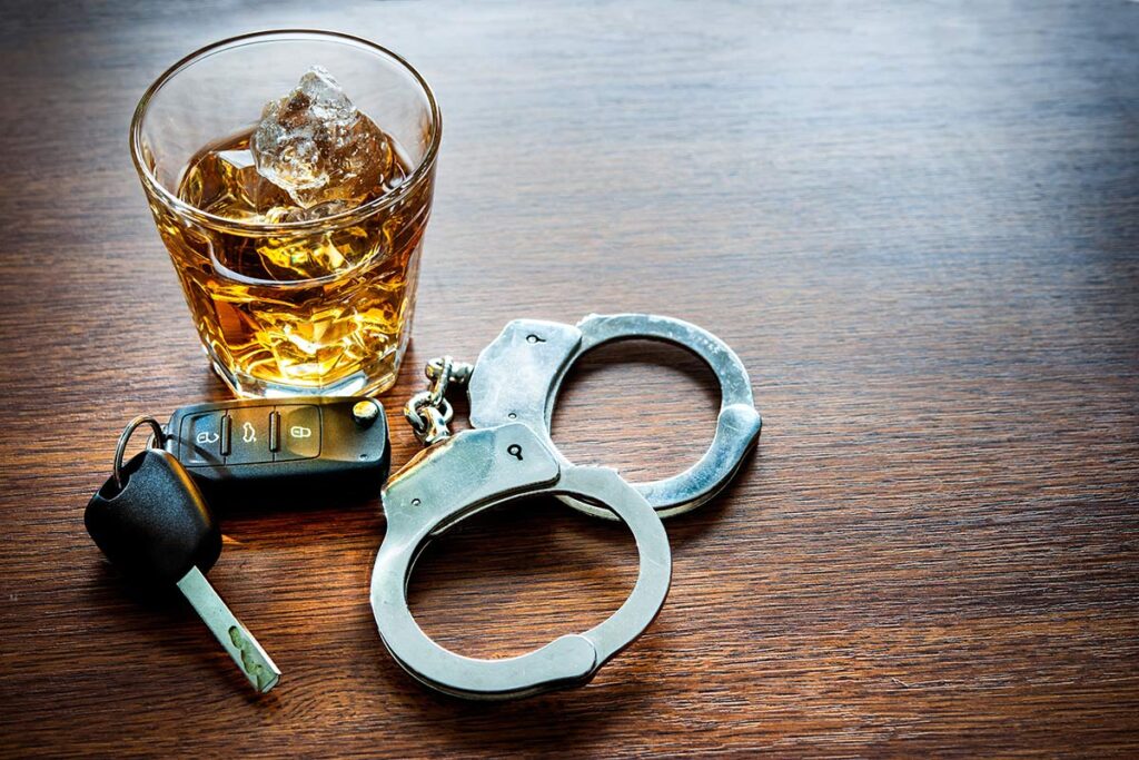 Top DUI attorney Rhode Island | Glass of whiskey next to keys and handcuffs | Experienced DUI Attorney | Stefanie A. Murphy